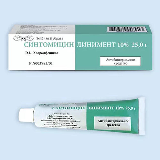 Green and white tube and box of Symptomycin Liniment on a light blue background