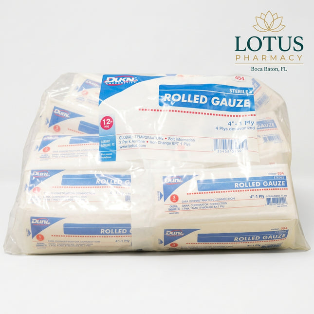 A bulk plastic bag containing multiple rolls of Dura-Mat rolled gauze, with white rolls wrapped in blue and white labels.