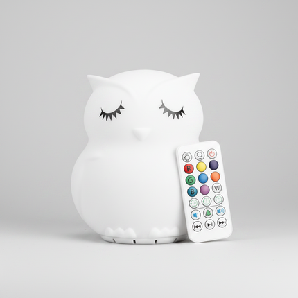 A white owl-shaped night light with closed eyes 