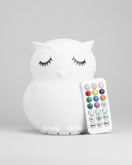 A white owl-shaped night light with closed eyes 