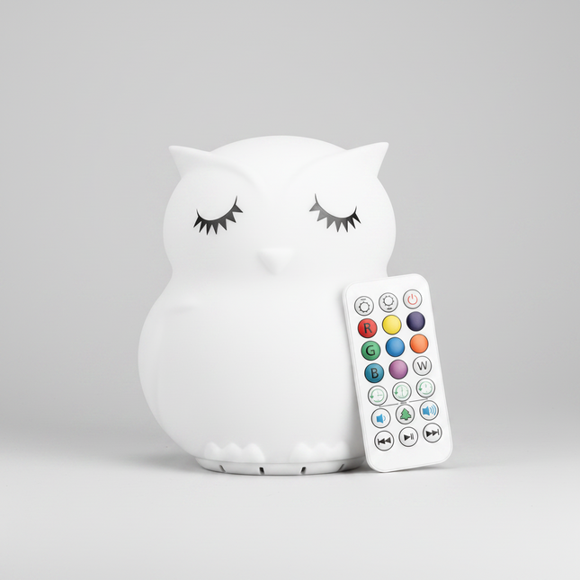 A white owl-shaped night light with closed eyes 