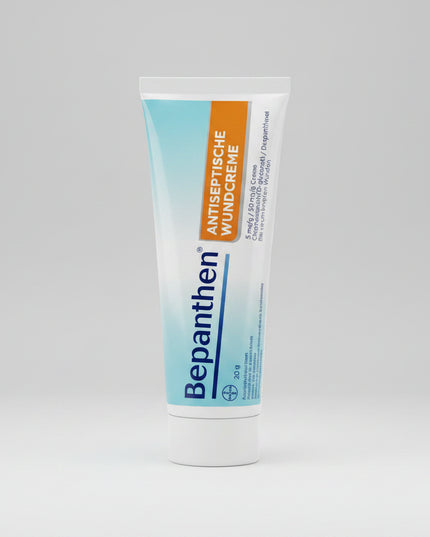 BEPANTHEN® Antiseptische Wundcreme is a German pharmaceutical wound cream specially formulated for the antiseptic treatment of superficial wounds and prevention of wound infections. The dual-action formula combines Chlorhexidine, an effective antiseptic agent, with Dexpanthenol (Provitamin B5) to support natural skin regeneration and healing. It is ideal for minor cuts, scrapes, abrasions, scratches, and superficial skin injuries. The cream provides a pleasant cooling effect and absorbs quickly into the ski