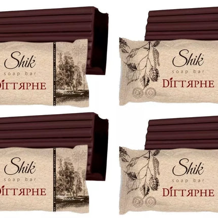 Four packages of Shik soap bars with decorative labels on a white background