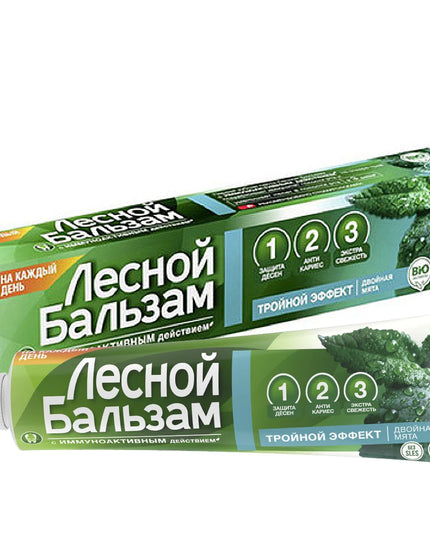 Green toothpaste packaging with text on a white background