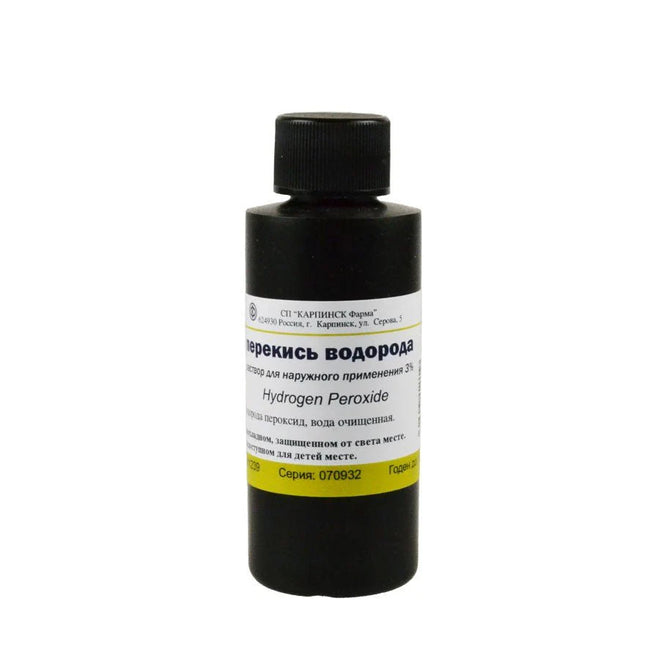 Bottle of hydrogen peroxide with a black cap on a white background