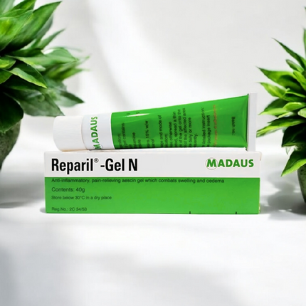 Madaus Reparil-Gel N tube on a white background with green plants