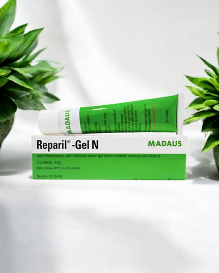 Madaus Reparil-Gel N tube on a white background with green plants