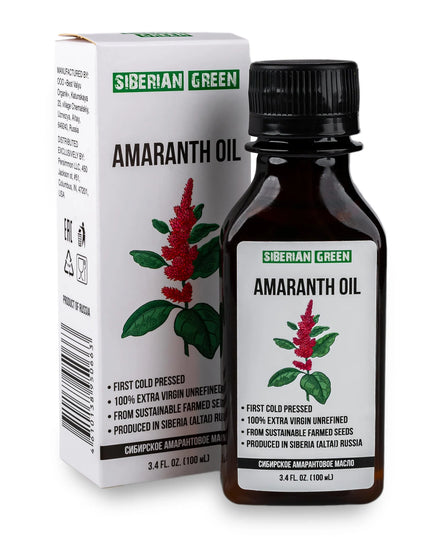 A bottle of Siberian Green Amaranth Oil next to its packaging box. The bottle has a label with an image of the amaranth plant, and the box has product information and branding.