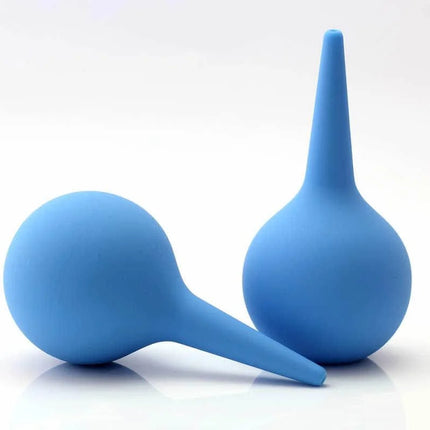 Two blue silicone enemas on a white background