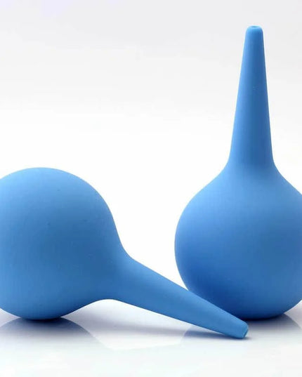 Two blue silicone enemas on a white background