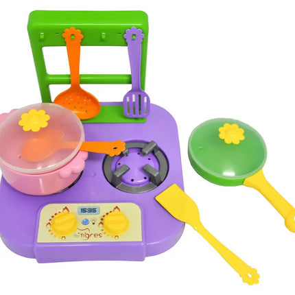 Colorful toy kitchen set with stove, pots, and utensils on a white background