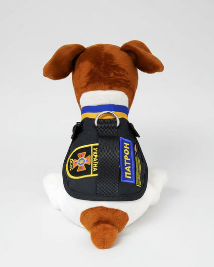 The toy is a stylized version of Patron, a Jack Russell Terrier who became well known in Ukraine for bomb-sniffing / demining work.
