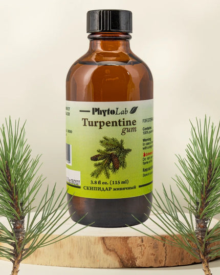 Bottle of PhytoLab Turpentine gum with pine branches on a beige background