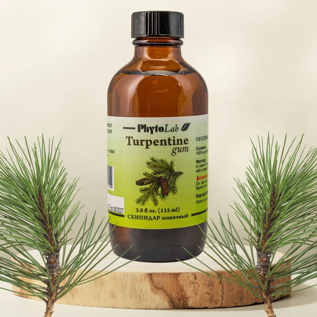 Bottle of PhytoLab Turpentine gum with pine branches on a beige background