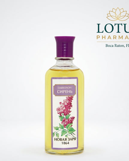 A clear glass bottle filled with pale yellow liquid, topped with a purple cap, and featuring a front label with a purple border, a lilac flower illustration, and Cyrillic text reading 'ОДЕКОНОМ СИРЕНЬ' and 'НОВАЯ ЗАРЯ 1864'.