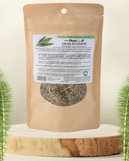 Kraft paper packaging with a label featuring dried herbs on a wooden surface with decorative plants.