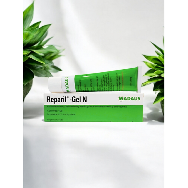 Madaus Reparil-Gel N tube on a white background with green plants