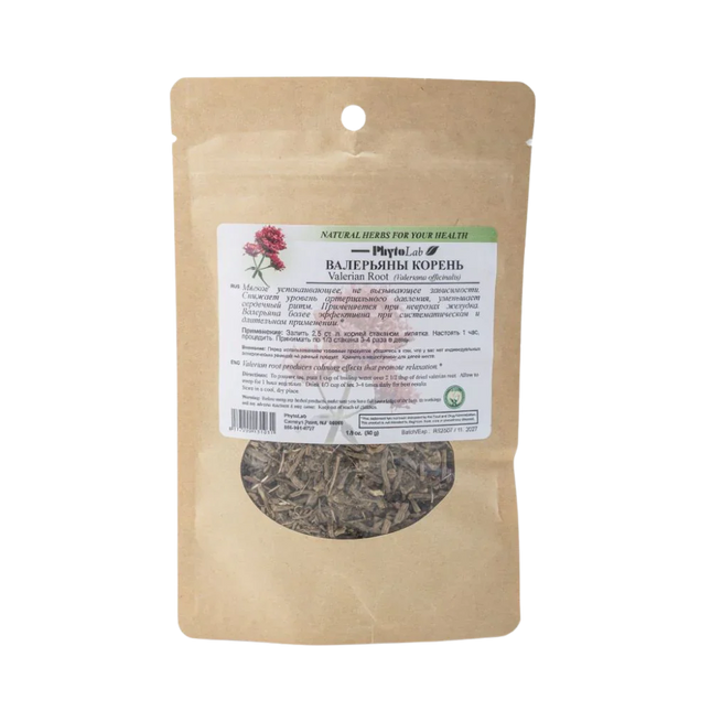 Brown paper bag with dried herbs and a label on a white background