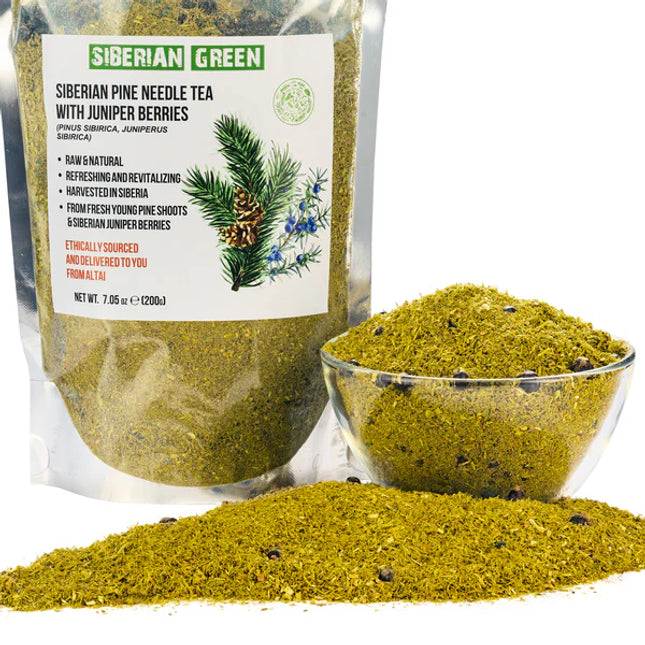 Siberian Green pine needle tea packaging with a bowl of tea and scattered leaves on a white background